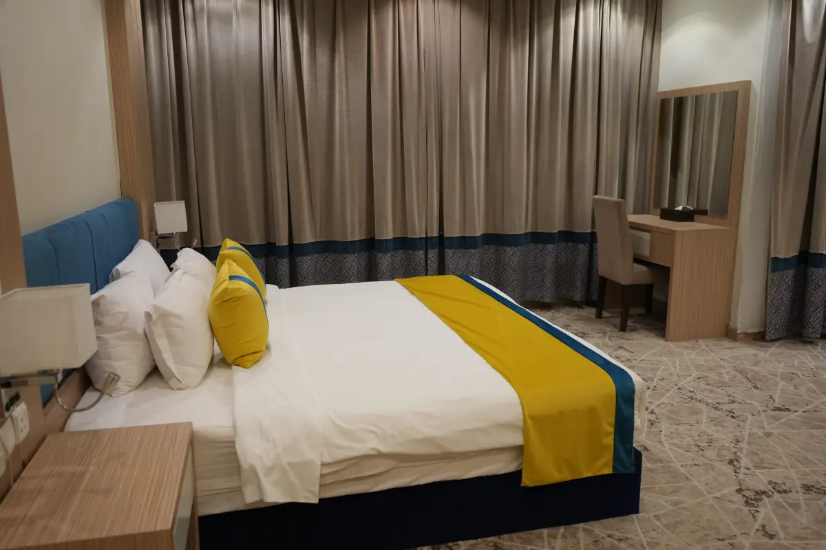 A spacious, luxurious suite with a bedroom and lounge area—perfect for long stays or families.